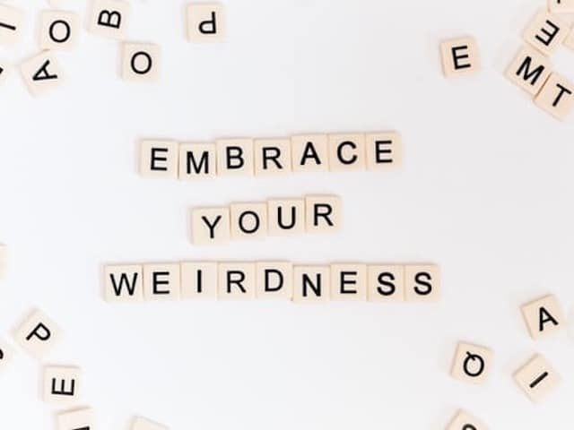 Image of meme with words "Embrace your Weirdness" in crossword Scrabble letters.