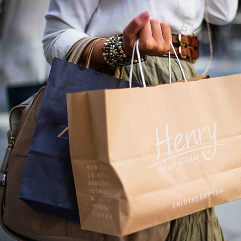 Image of well dressed woman carrying a shopping bag